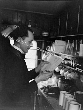 WAITER WITH MENU IN GALLEY KITCHEN